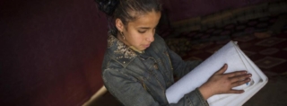 12-year old Rafah practices reading Braille in her family's shelter in Fayda tented settlement, in the Bekaa Valley (Lebanon, 2014). © UNHCR/Andrew McConnell